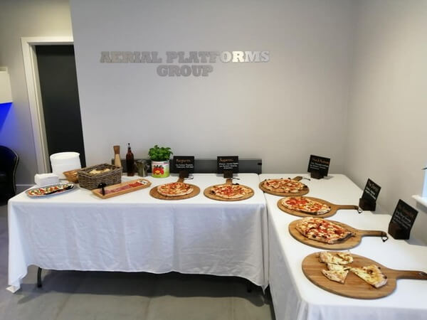 Buffet table for a corporate event full of pizza